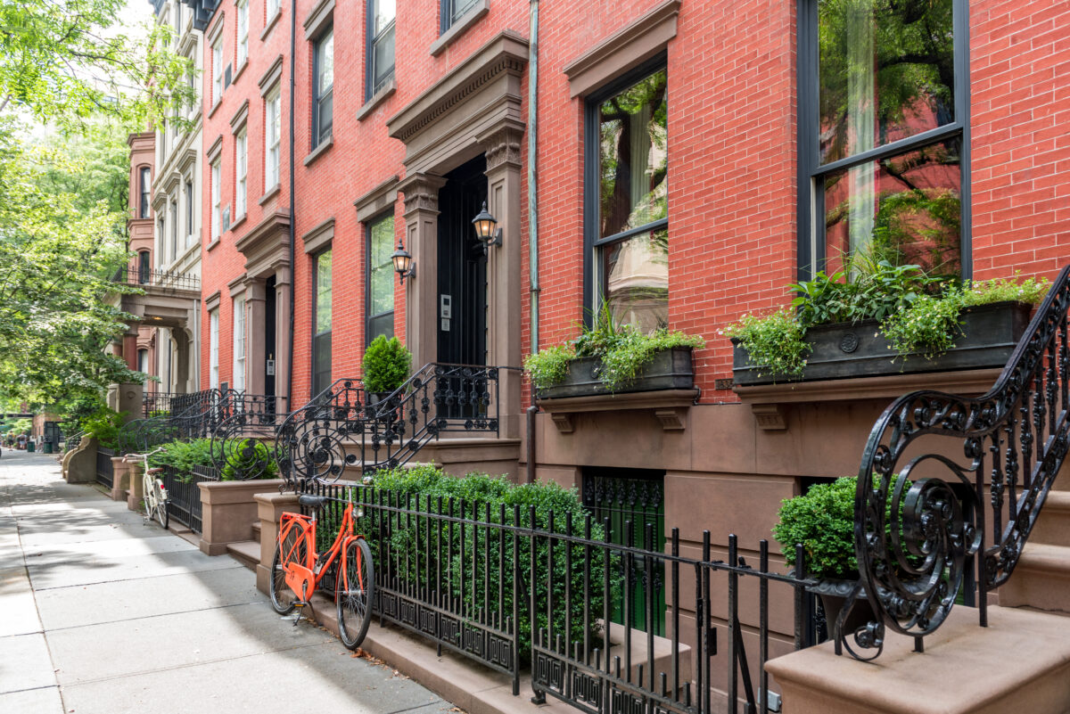 Two,Bicycles,In,Front,Of,A,Brownstone,Building,In,Neighborhood