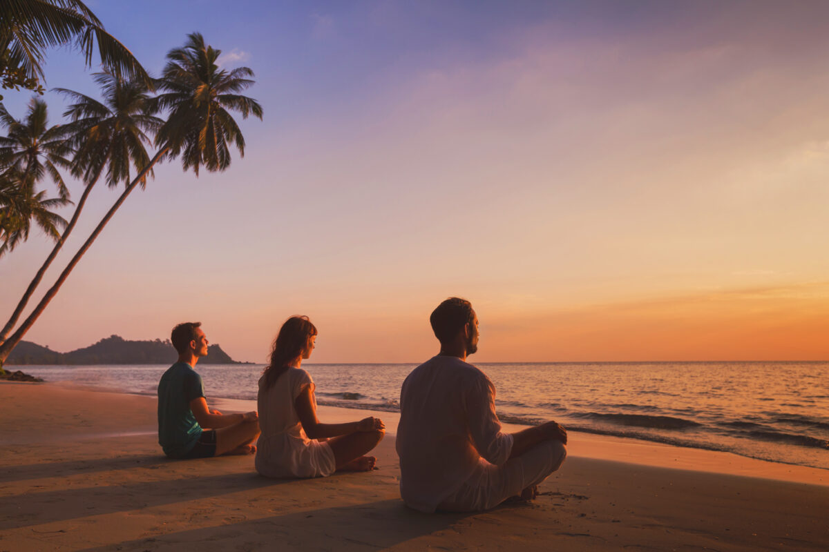 Yoga,Retreat,On,The,Beach,At,Sunset,,Silhouettes,Of,Group